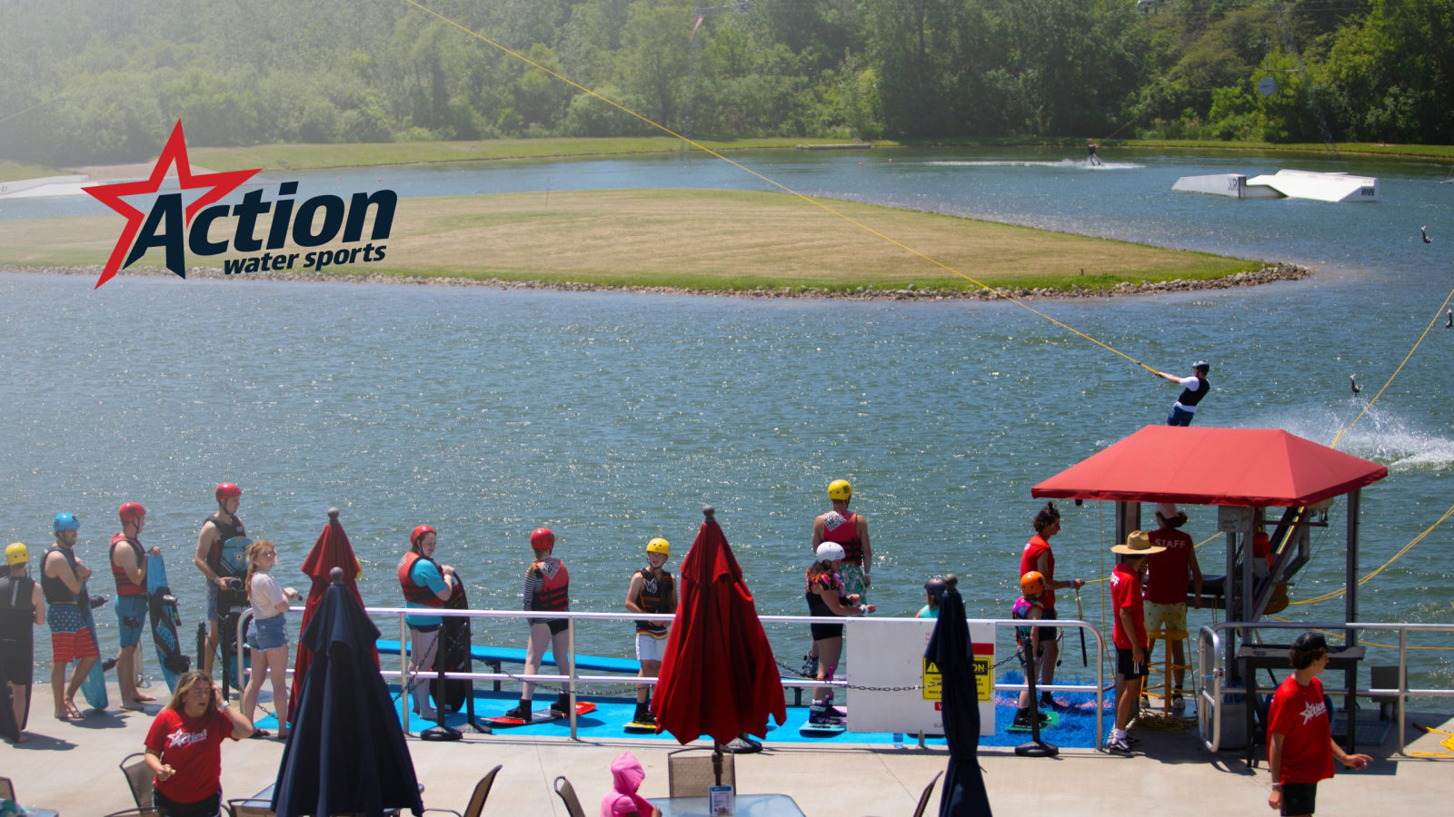 Crowd waits dockside as a wakeboarder rides a cable system at Action Wake Park.