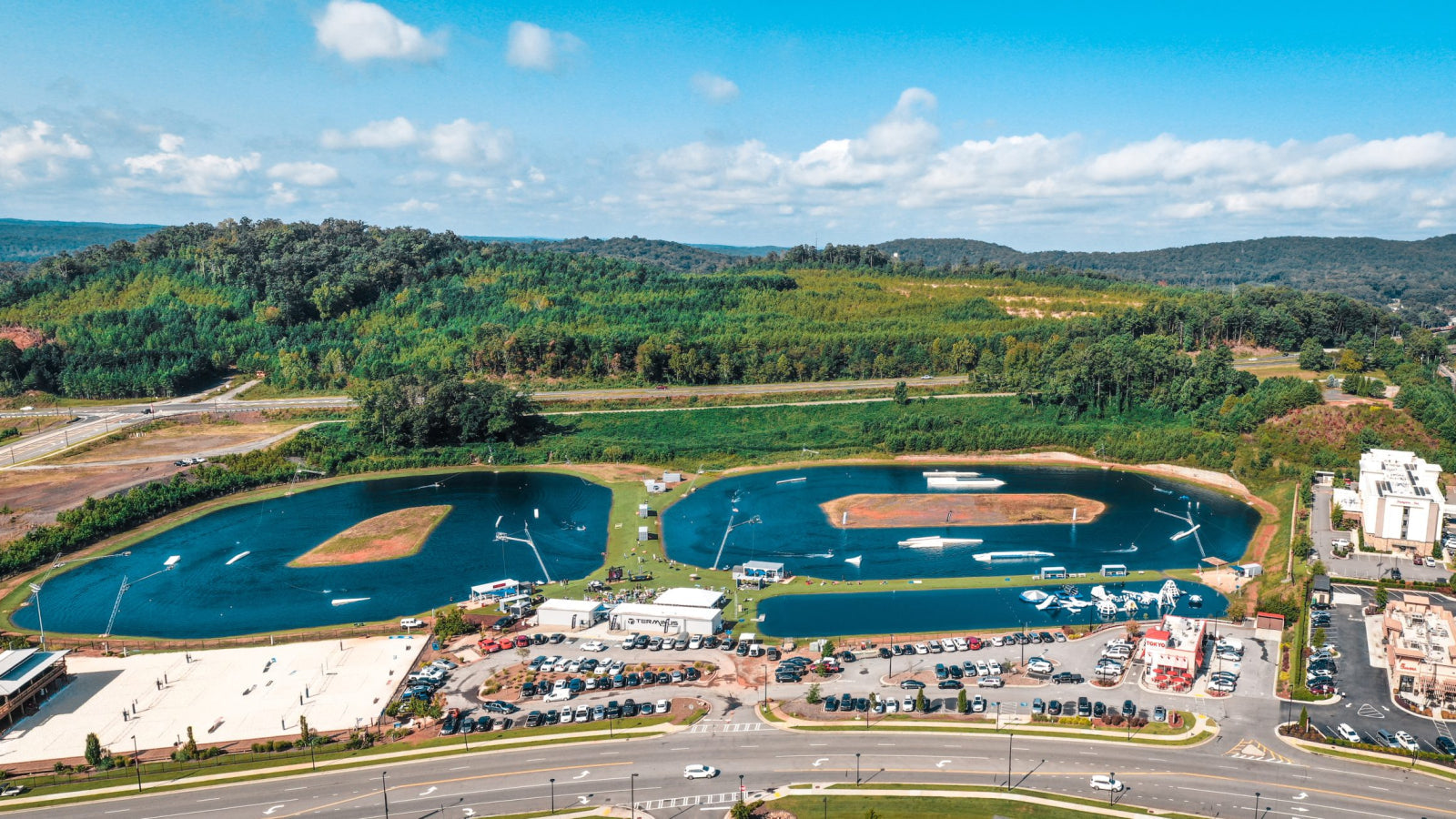 Aerial view of Terminus Wake Park with two cable lakes, grassy islands, and parking areas.