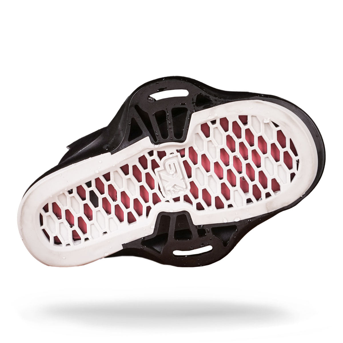Wakeboard bindings with a white honeycomb pattern, red beneath, and black edges.