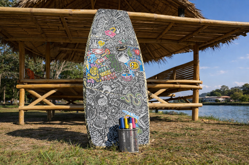 Decorated wakeskate with markers leaning against a wooden structure by a body of water.