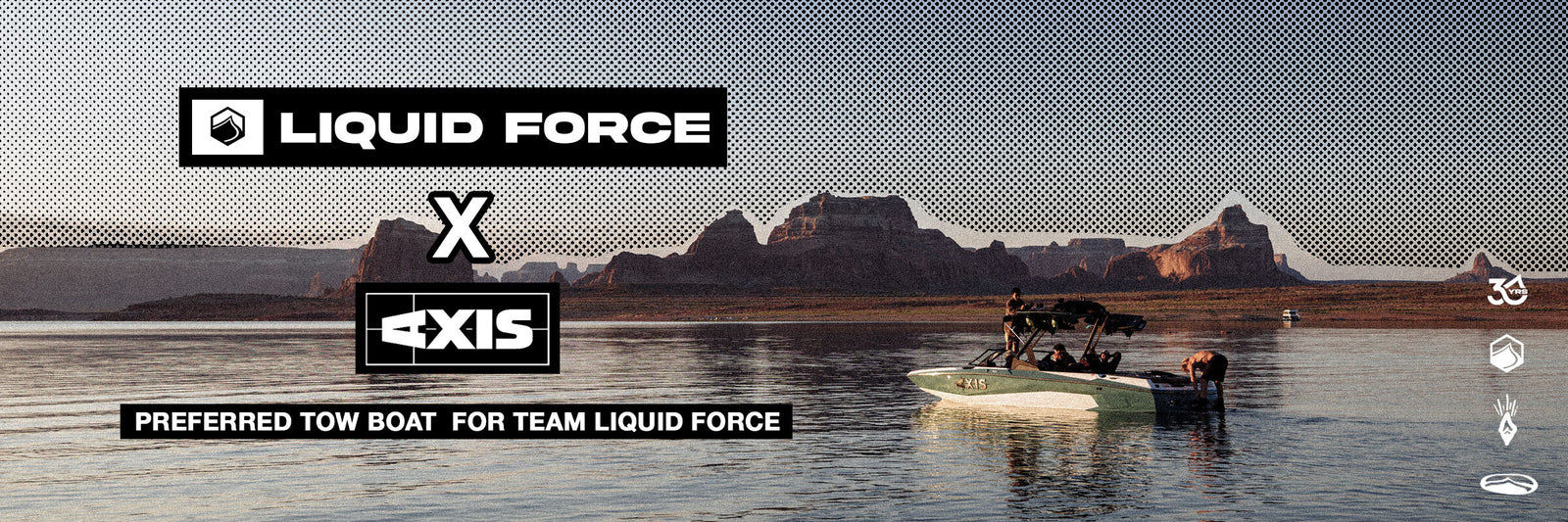 Green and white AXIS boat floating on the lake with red rocks in the background and a logo stating " Preferred tow boat for team LiquidForce