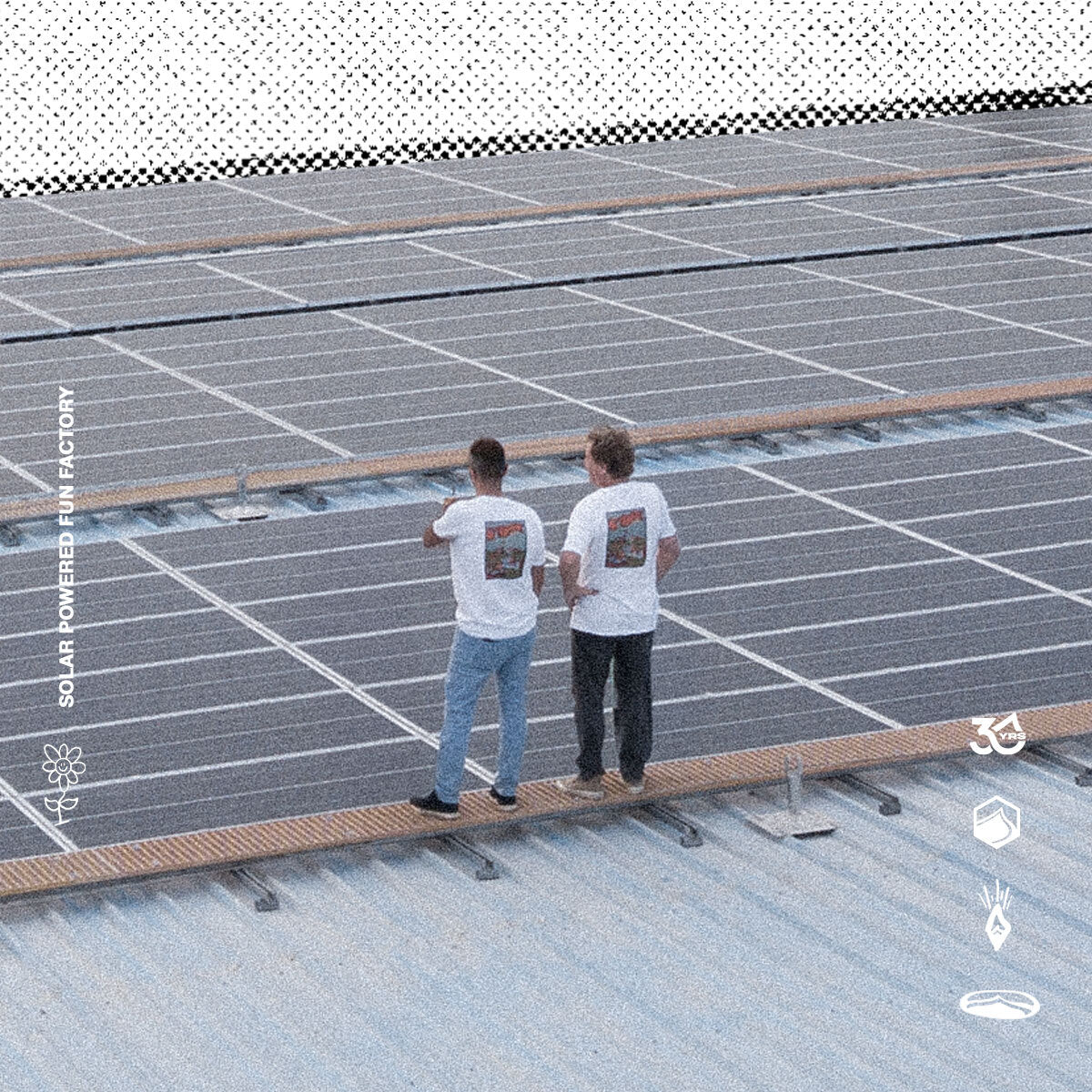 Two people inspecting solar panels on a rooftop with 'Solar Powered Fun Factory' branding.