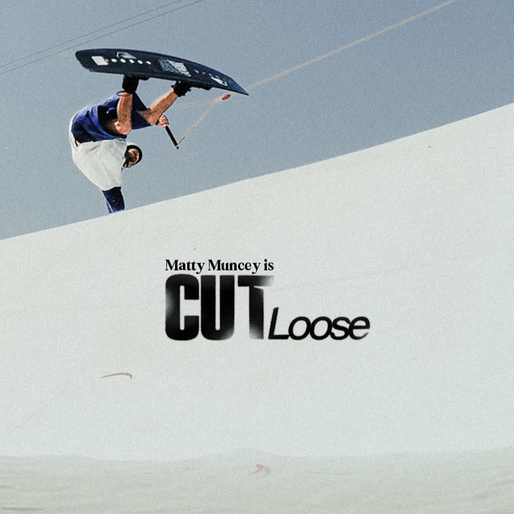 Person on a sand dune with an umbrella, text overlay 'Matty Muncey is Cut Loose' on a clear sky background