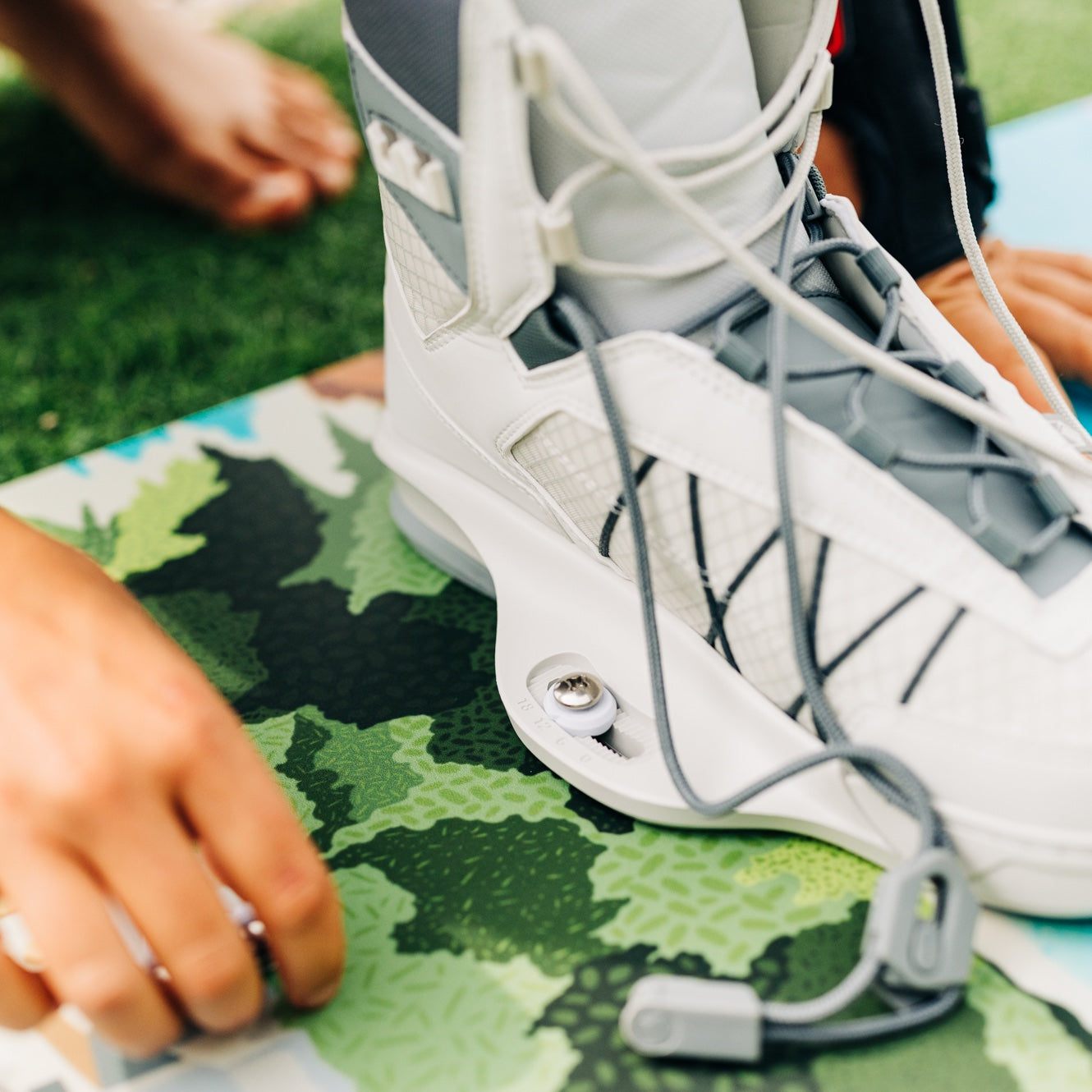 Zoomed in shot of rider mounting bindings on a board.