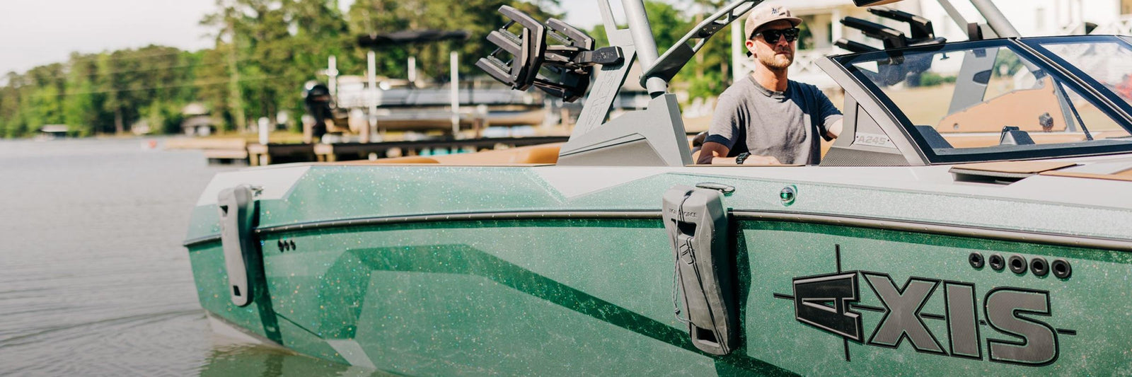 Liquid Force Board Boat & Dock Collection - Closeup shot of someone driving a boat and pulling into a dock at a marina