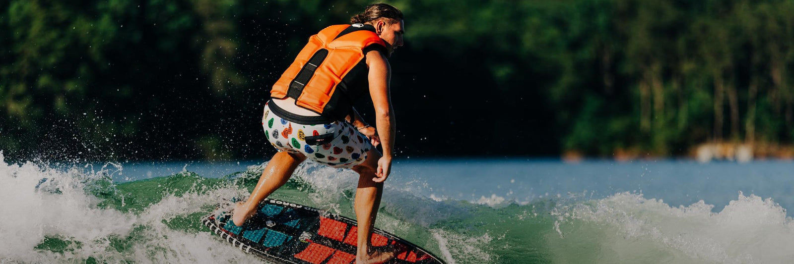 Liquid Force CGA Vest Collection - Closeup shot of LF Athlete Jake Caster wake surfing while wearing a LF CGA Life Jacket