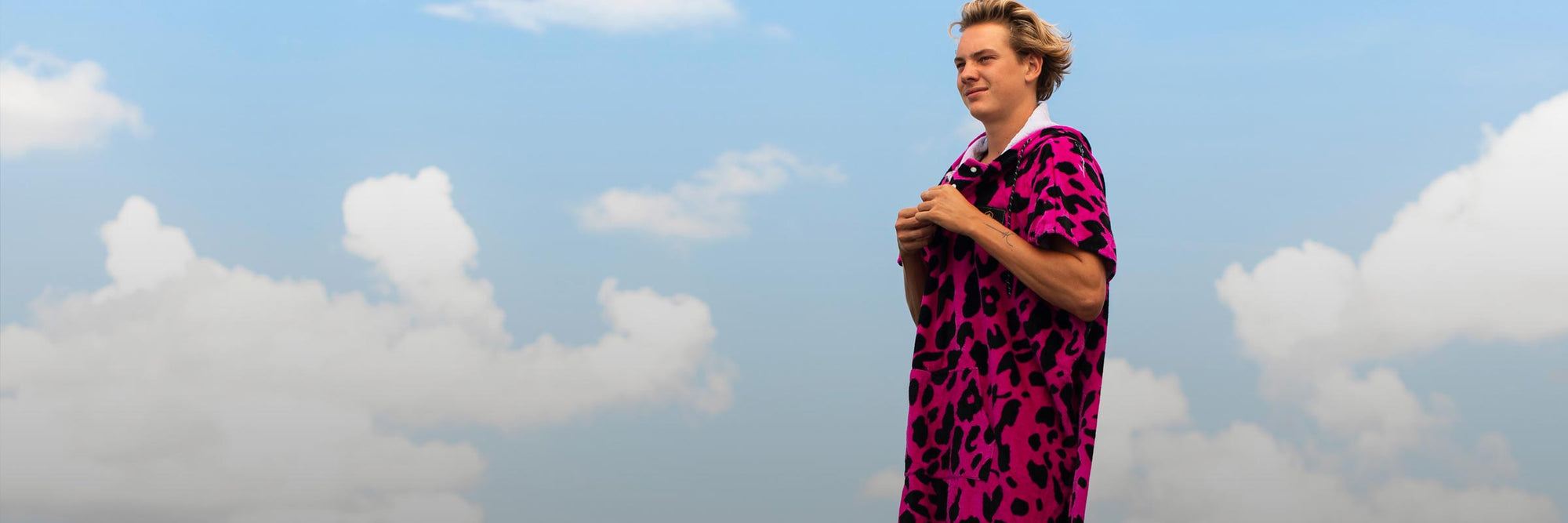 Liquid Force Changers & Towels Collection - Close up picture of LF Athlete Sam Brown in a LF Changer Towel with the sky behind him