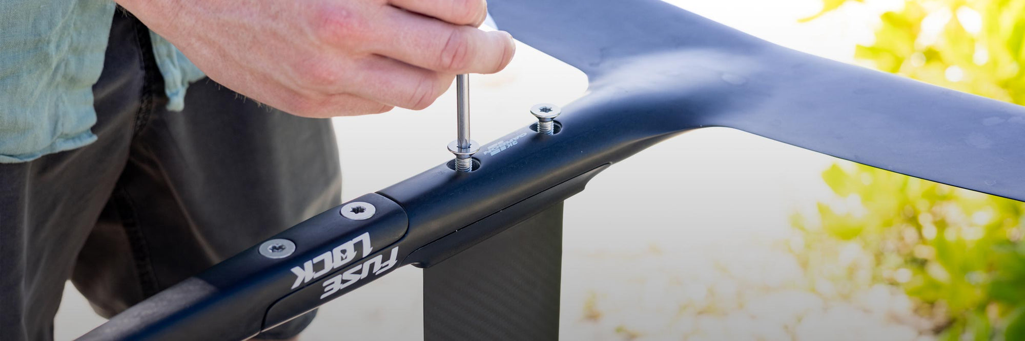 Liquid Force Foil Component Collection - Close up picture of someone mounting a Liquid Force Foil together with an Allen Wrench.