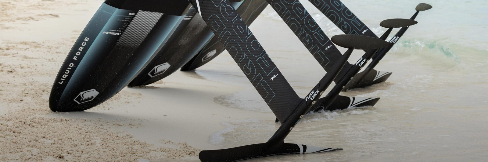 Liquid Force Foil Set Collection - Three fully mounted foil boards with mounted foil lowers staged on the beach