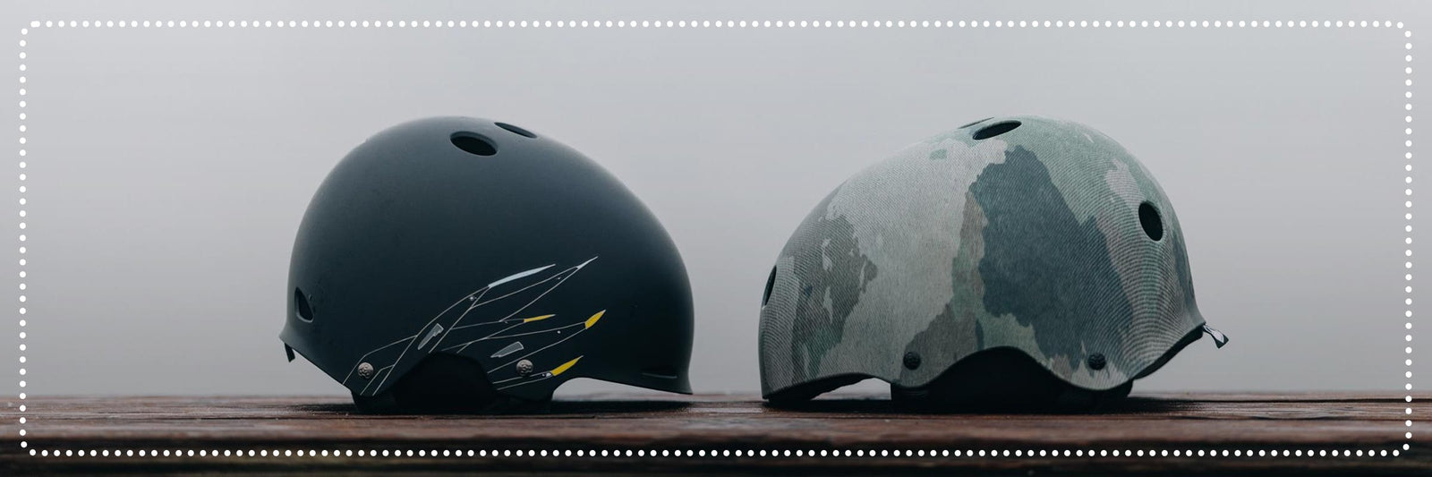Liquid Force Clearance Helmets Collection - Two LF Wakeboard helmets sitting on wood facing each other.