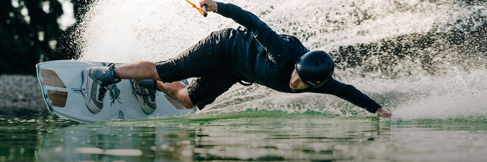 Liquid Force Park Wakeboard Package Collection - Closeup shot of LF Athlete Nico Von Lerchenfeld carving hard around a corner at a cable park