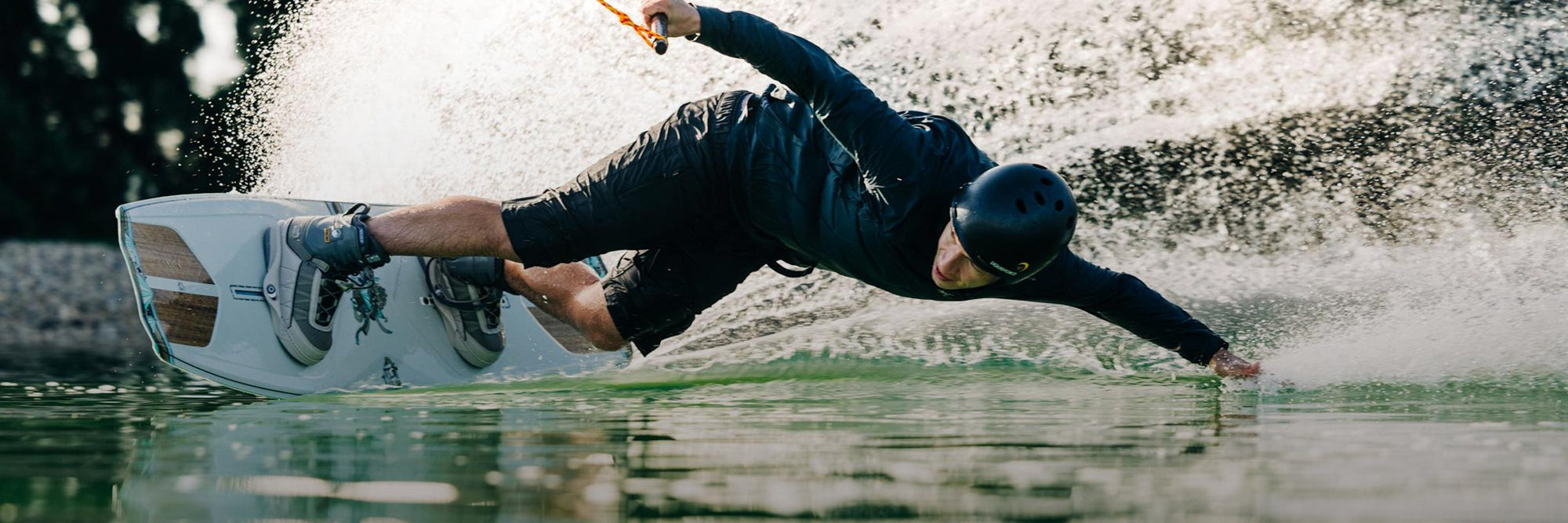 Liquid Force Park Wakeboard Package Collection - Closeup shot of LF Athlete Nico Von Lerchenfeld carving hard around a corner at a cable park