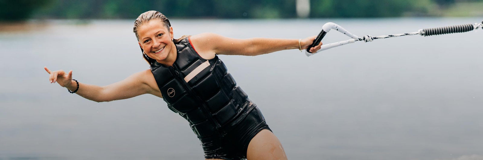 Liquid Force Ropes & Handle Collection - Close up picture of LF Athlete Bailey Dunn holding on to a LF Rope/Handle Combo while wakesurfing