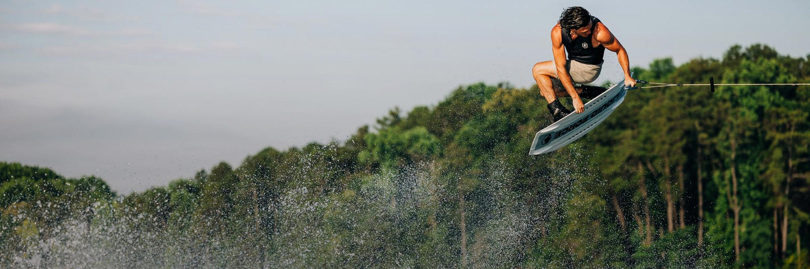 Liquid Force Boat Wakeboard Collection - Closeup shot of LF Athlete Fynn Bullock grabbing his wakeboard in the air.