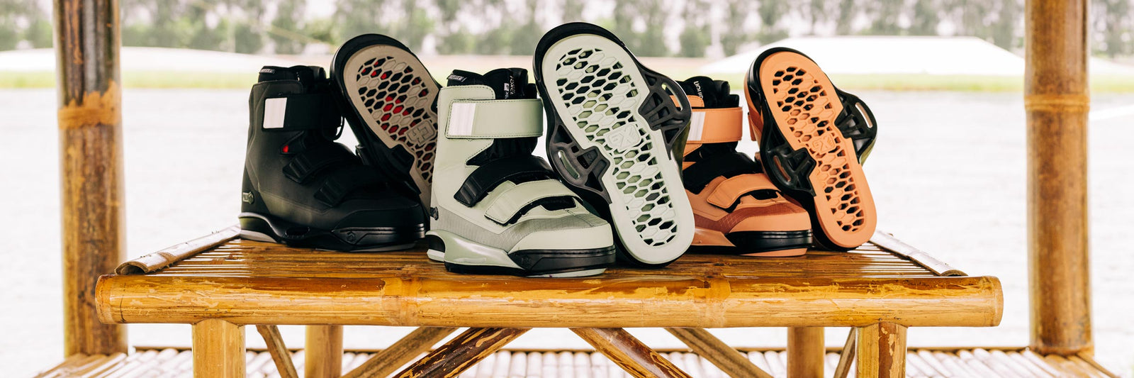 Black, mint, and orange wake bindings displayed on a bamboo table outdoors.