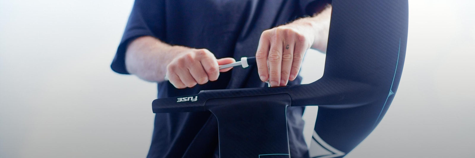Close-up of hands tightening a screw on a carbon foil setup.