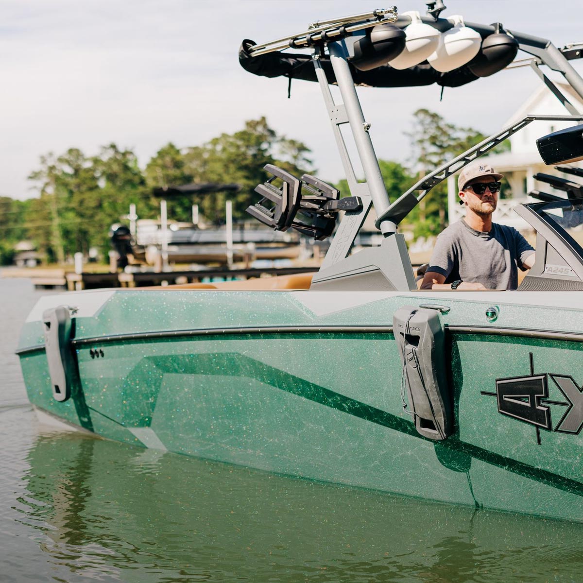 Liquid Force Board Boat & Dock Collection - Closeup shot of someone driving a boat and pulling into a dock at a marina