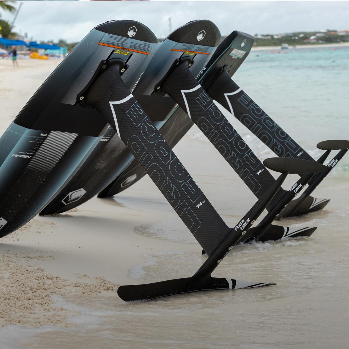 Liquid Force Foil Set Collection - Three fully mounted foil boards with mounted foil lowers staged on the beach