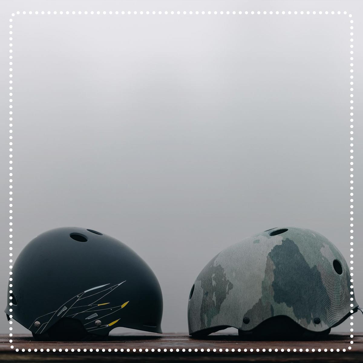 Liquid Force Clearance Helmets Collection - Two LF Wakeboard helmets sitting on wood facing each other.