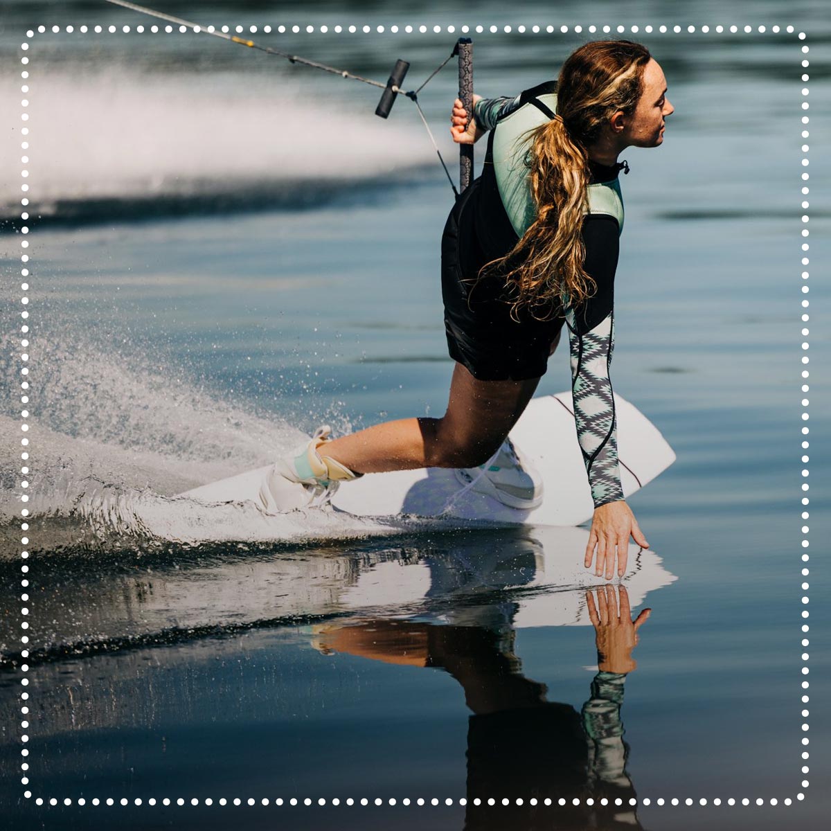 Liquid Force Clearance Wakeboards Collection - LF Athlete Daniel Meagan Ethell carving out into flat water on her wakeboard setup.