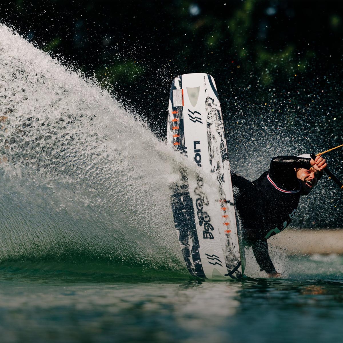 Liquid Force Park Wakeboard Collection - Closeup shot of LF Athlete Matty Muncey carving around a corner at a cable park on a wakeboard.