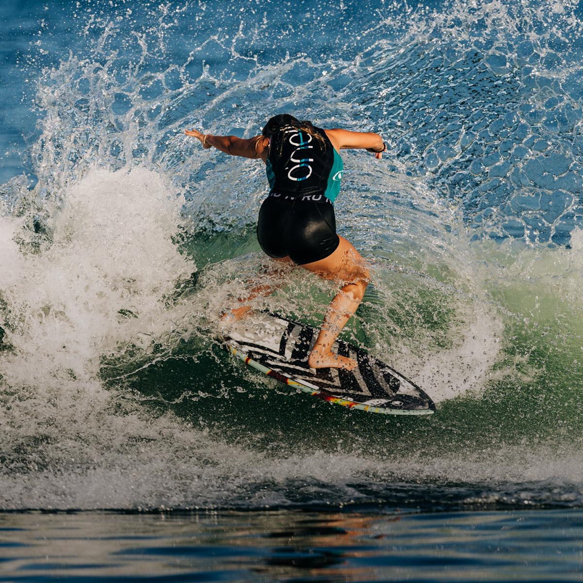 Liquid Force Skim Style Wakesurf Collection - Closeup shot of LF Athlete Bailey Dunn carving hard on a wakesurf board