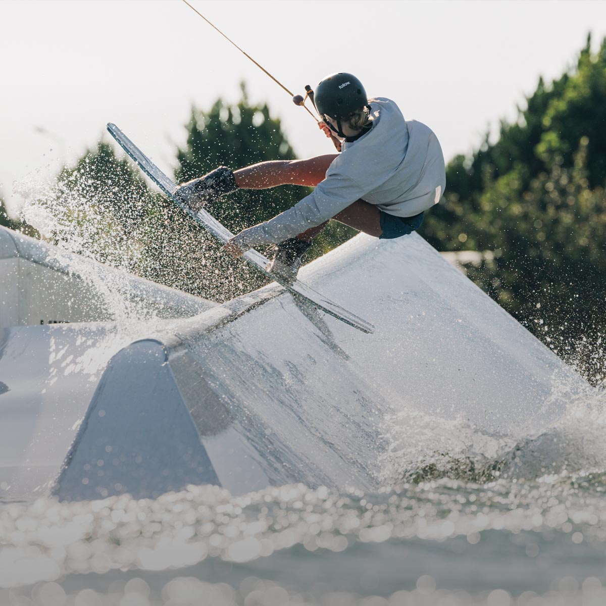 LF Team Rider Rivers Hedrick grinding on a rail at a cable park.