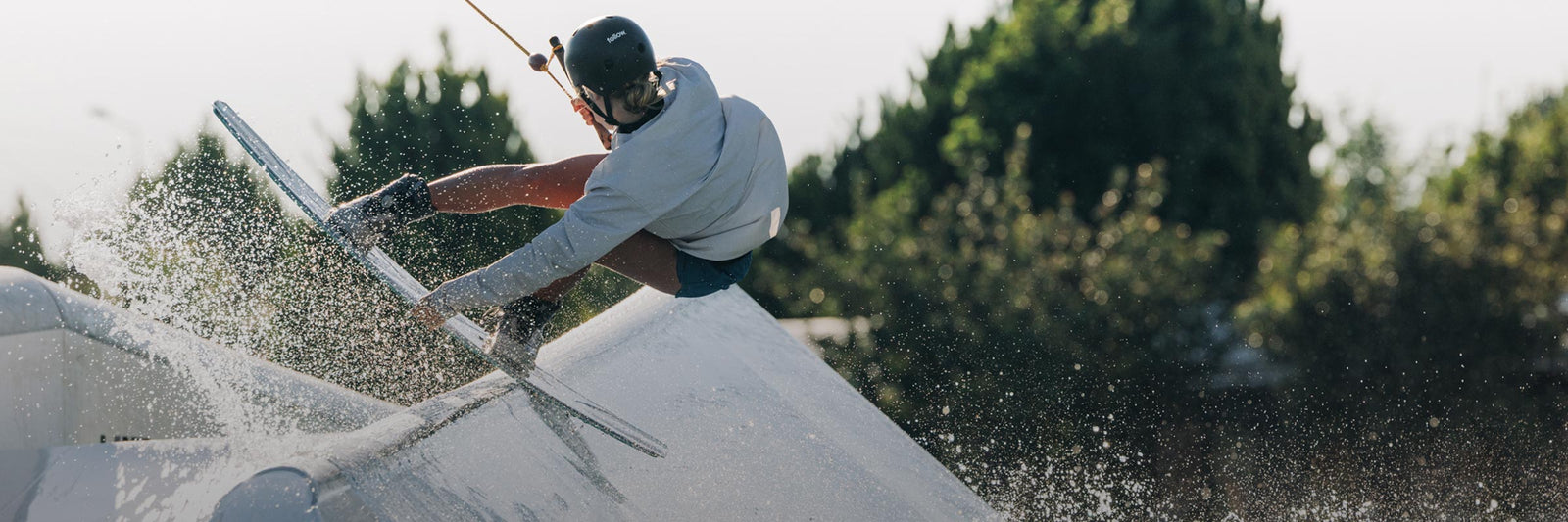 LF Team Rider Rivers Hedrick grinding on a rail at a cable park.