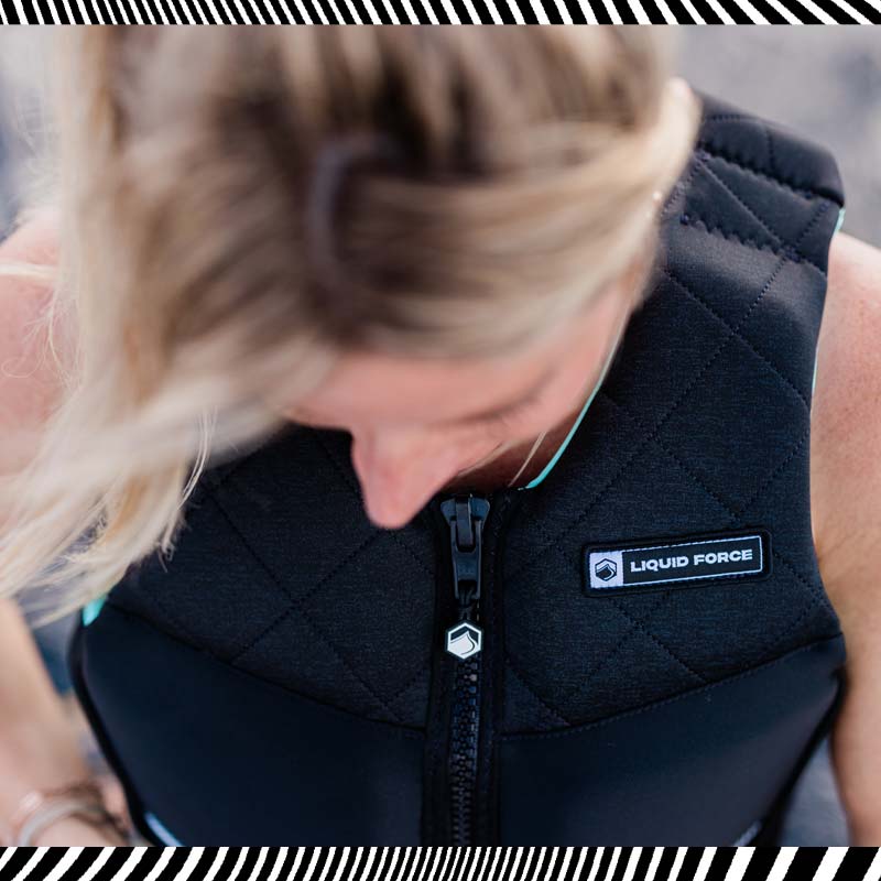 A closeup of a person wearing a Liquid Force Vest