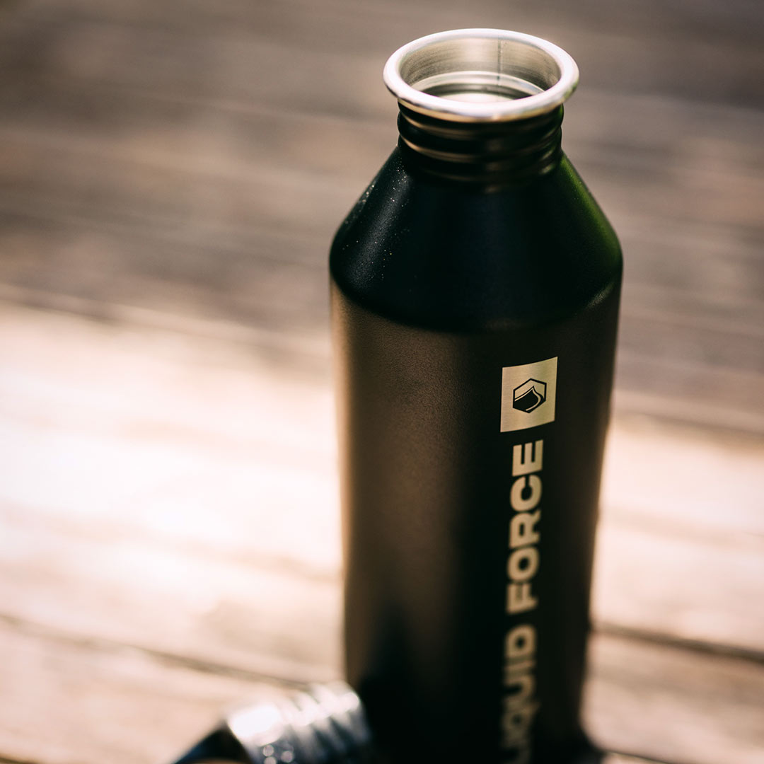 LF x MIZU Water Bottle on a wooden surface in sunlight.
