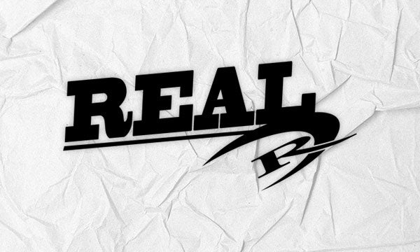 The bold word REAL in black with a stylized design on crumpled white paper.