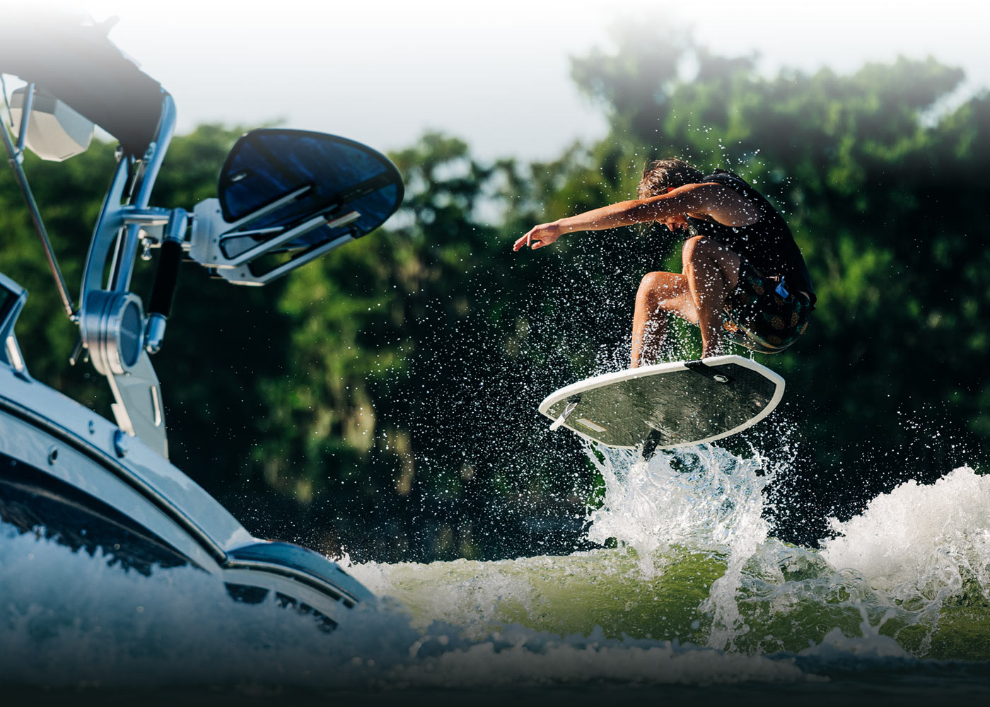 A thrill-seeker wakeboarding near a boat, catching air over the water.