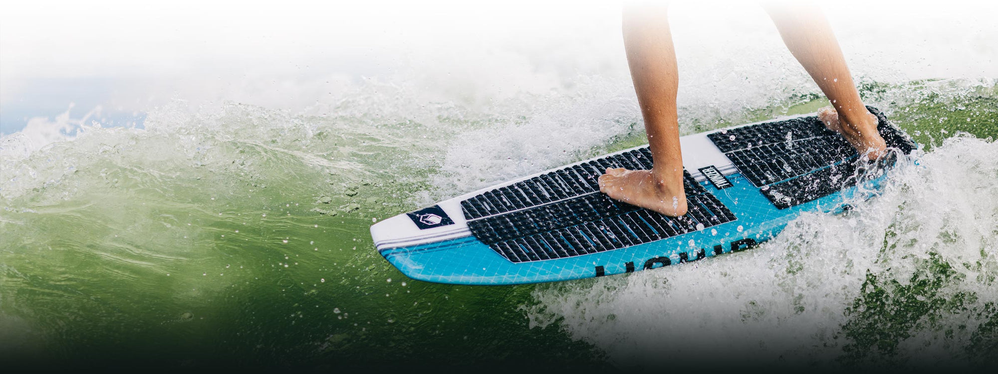 Surfer riding green waves on a vibrant board.