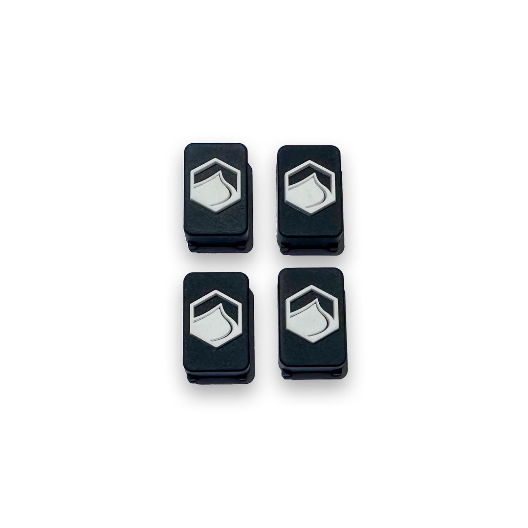 Angled Front View of Four black and white 4D FlexTrack Plugs, part of a hardware set for Liquid Force FlexTrack Wakeboards, on a white background.