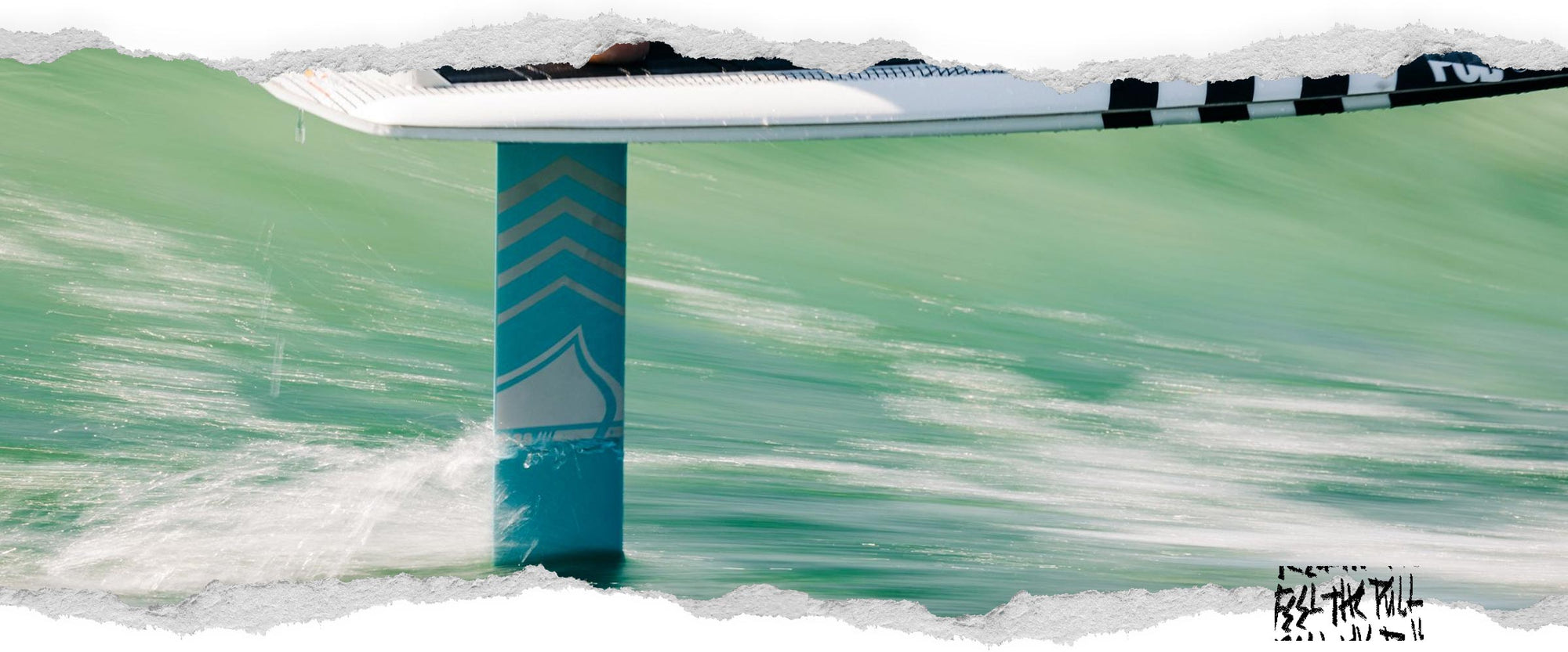 Liquid Force 28" alloy foil mast cutting through bright green water.