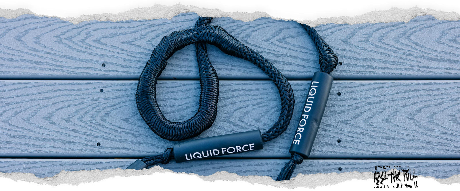 Black Liquid Force dock ties resting on light blue textured deck boards.