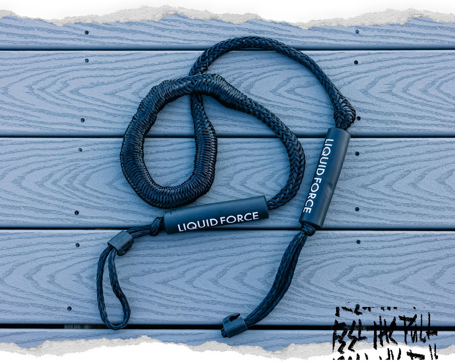 Black Liquid Force dock ties resting on light blue textured deck boards.