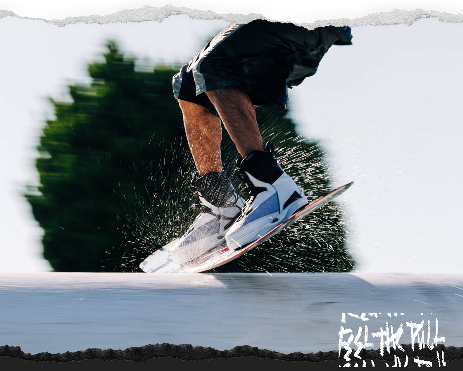 Mid-trick motion shot with rider centered on white board.