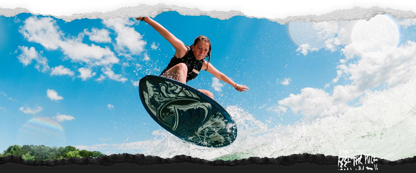 Woman surfing a wave on the Liquid Force Blade Wakesurfer in a black vest.