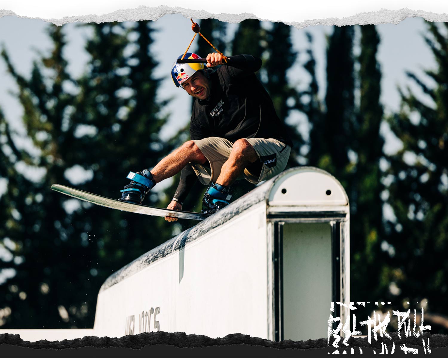 Wakeboarder rides a feature wearing blue boots and helmet with the Butterstick Pro board.