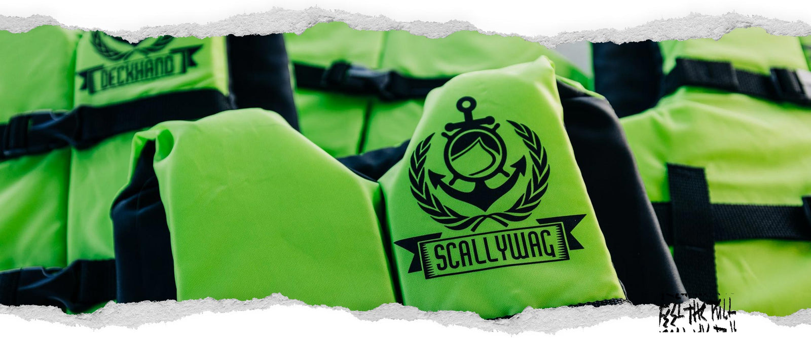 Close-up of neon green CGA vest with Scallywag label and anchor logo, surrounded by similar vests.