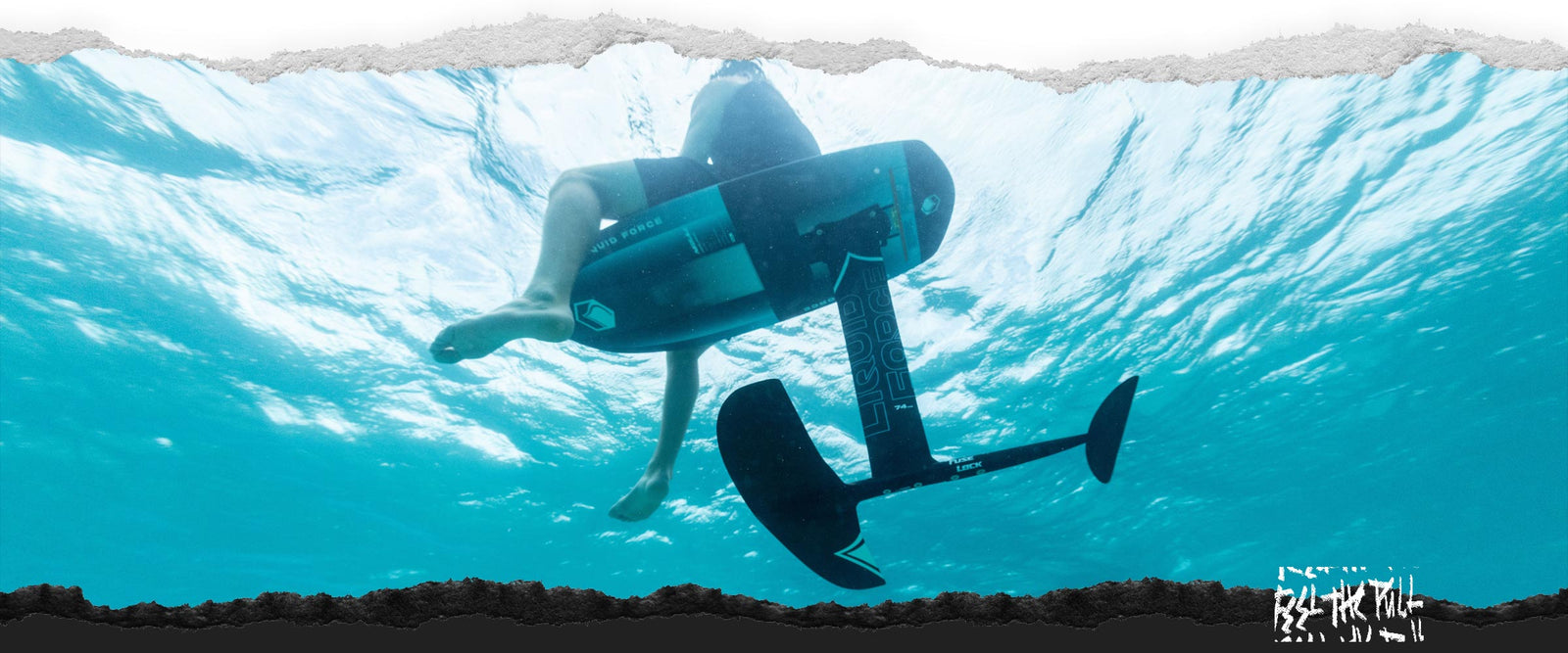 Angled underwater view of Liquid Force Carbon Horizon foilset in bright blue water.