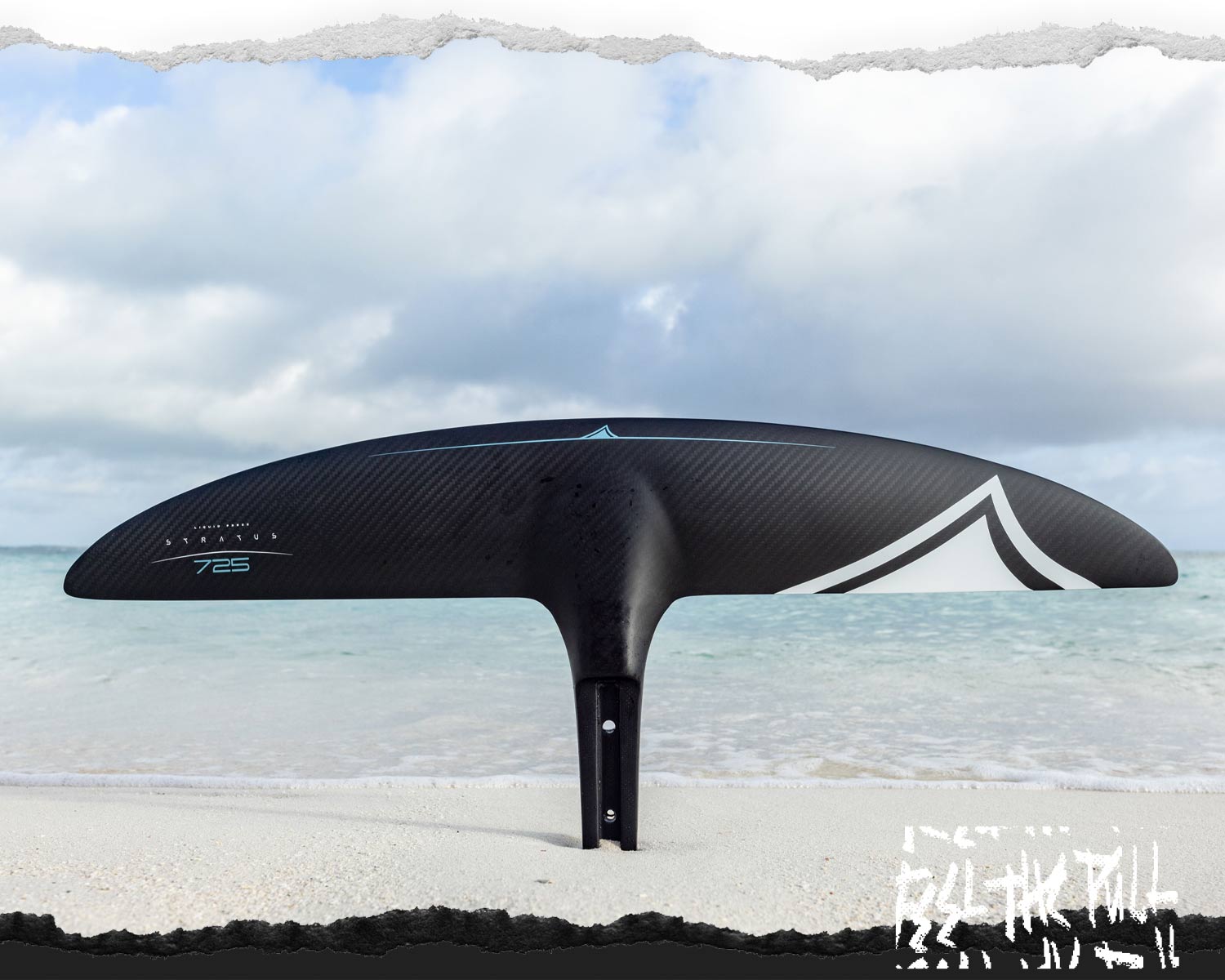 Black Carbon Stratus 725 foil wing displayed vertically on a sandy beach.
