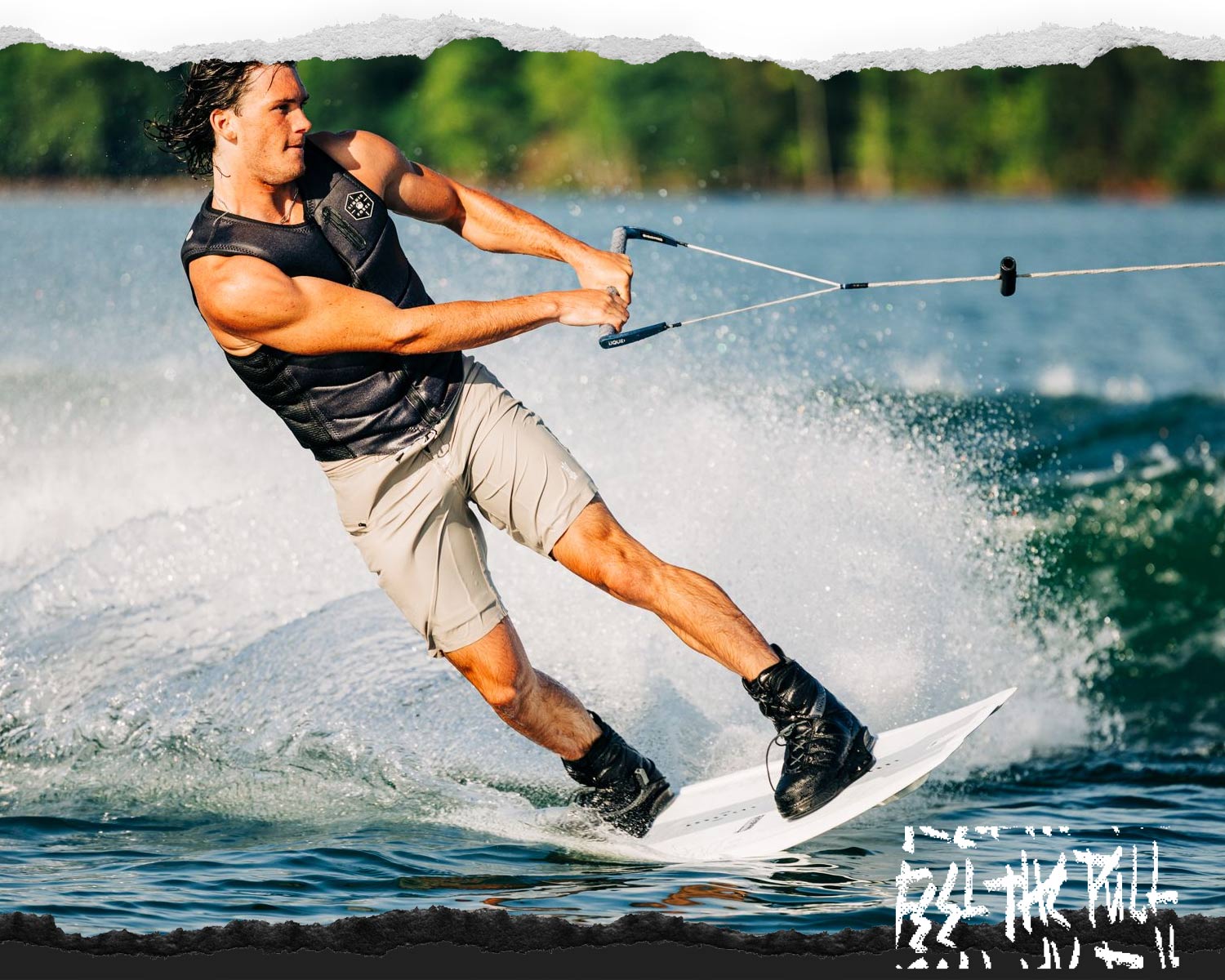 Action shot of rider carving hard in a black vest on a white board.