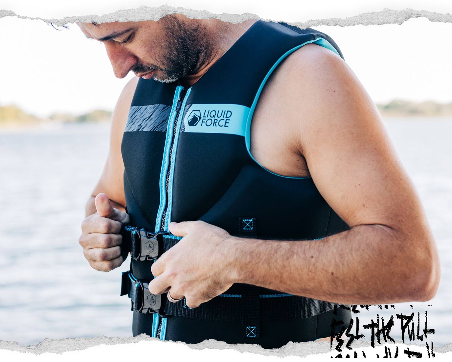 Man tightening black and blue Classic Hinge CGA vest with Liquid Force logo at lakeside.
