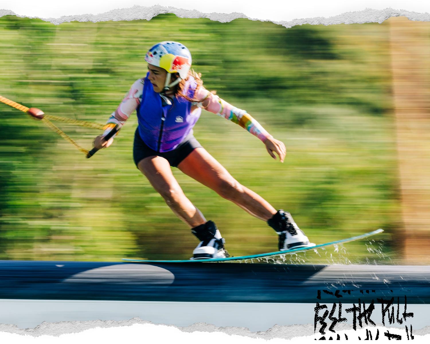 Rider in purple vest grinds across water surface while wakeboarding at high speed.