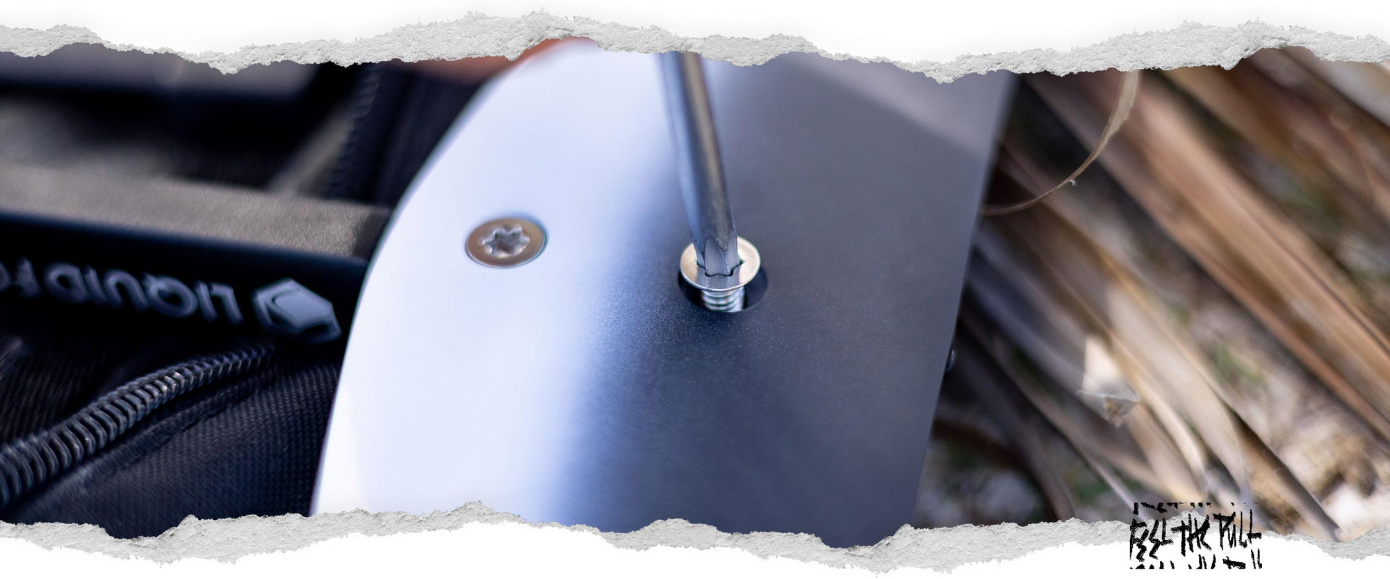 Side view of a foil wing being screwed into place, showing Liquid Force branding.