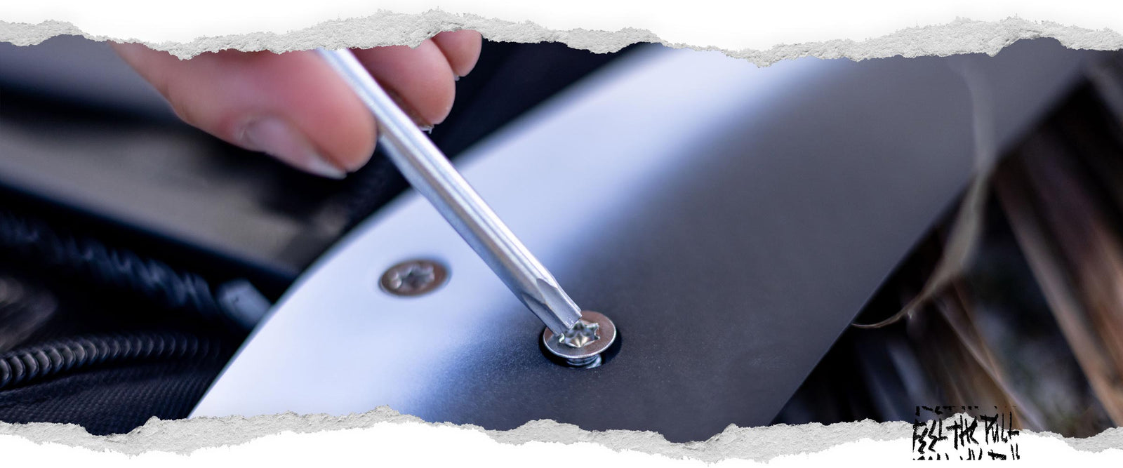 Close-up of screwdriver tightening a foil wing screw on a Liquid Force hydrofoil.