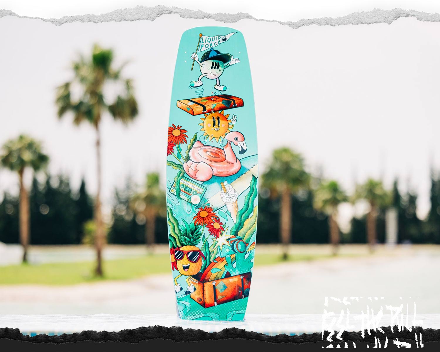 Picture of a the Liquid Force Holiday Future Series Wakeboard standing upright next to water's edge.