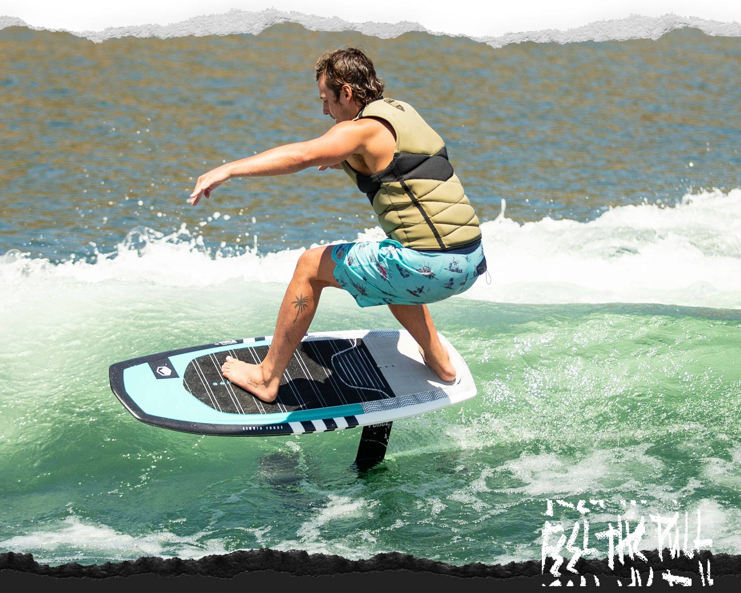 Rider foiling on Liquid Force Legacy Flite 120 above green wave in bright daylight.